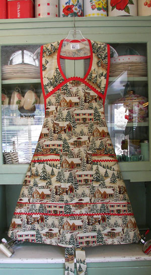1940 Old Time Village Christmas Apron with red trim and ric rac, click for larger view